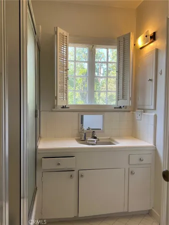 a kitchen with a sink and cabinets