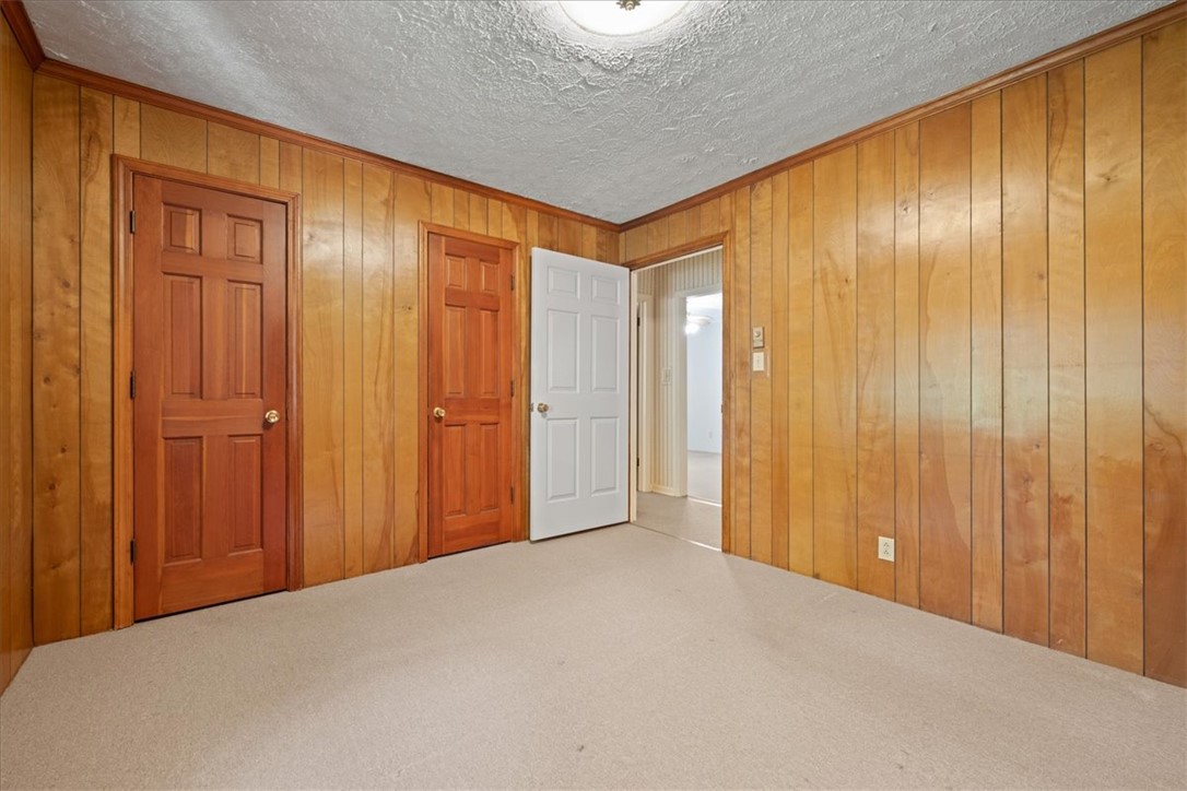 304 Shaw Road Honea Path, SC 29654 - Photo 18 of 39 This cozy room offers wood paneling and soft carpeting, creating a warm and inviting atmosphere.