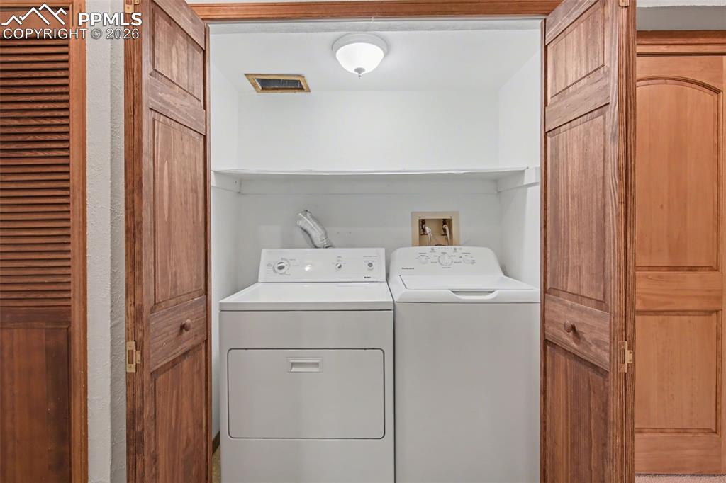 5301 Pinon Valley Road Colorado Springs, CO 80919 - Photo 14 of 27 a utility room with dryer and washer