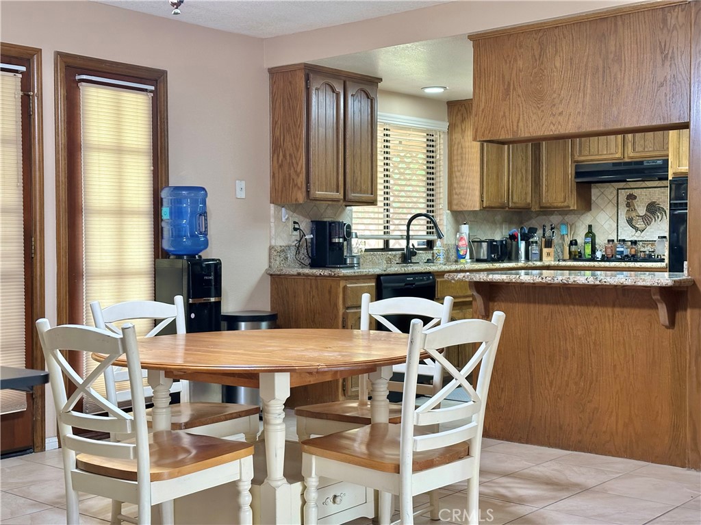 18143 Kalin Ranch Drive Victorville, CA 92395 - Photo 16 of 28 a view of a dining room with furniture and a window