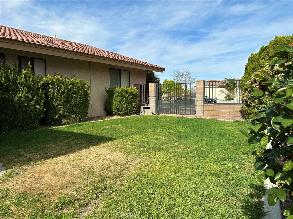 18143 Kalin Ranch Drive Victorville, CA 92395 - Photo 25 of 28 a view of a house with a garden