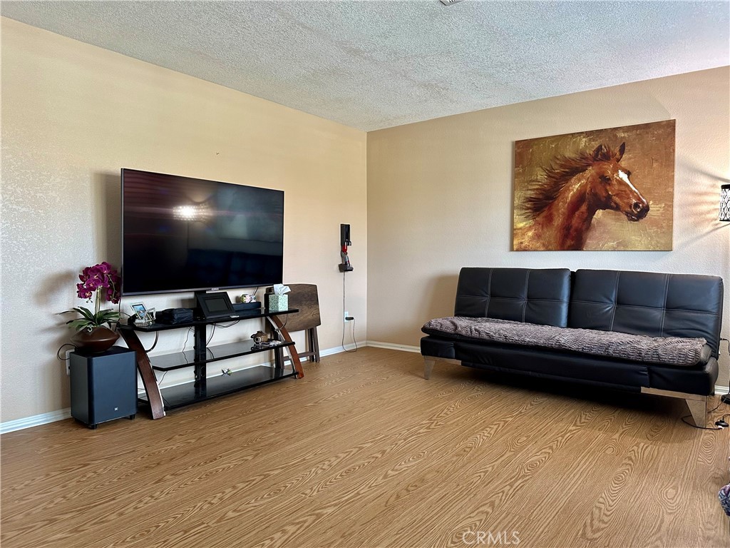 18143 Kalin Ranch Drive Victorville, CA 92395 - Photo 10 of 28 a living room with furniture and a flat screen tv