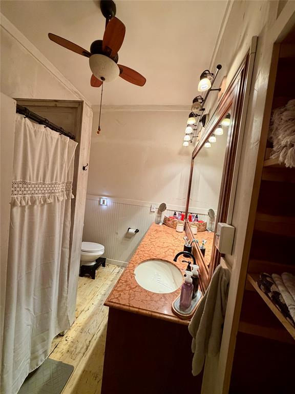 301 Forrest Avenue Cleburne, TX 76033 - Photo 13 of 14 Bathroom featuring a wood-finish vanity with an integrated basin, a large mirror, and track lighting