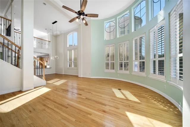 a view of a livingroom with wooden floor and a fireplace