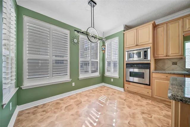 a kitchen with granite countertop a sink and stove