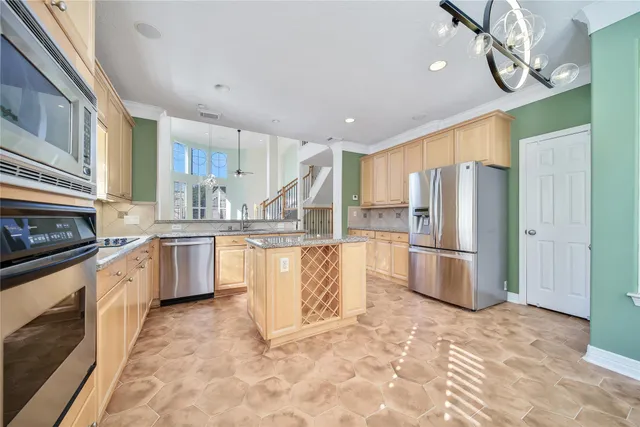 a large kitchen with cabinets and stainless steel appliances
