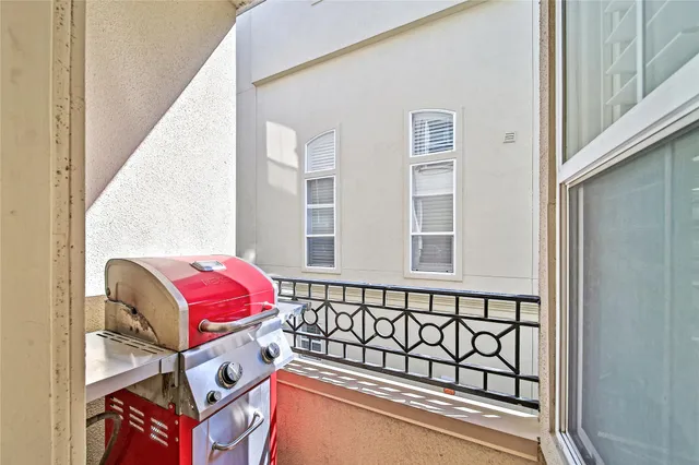 a kitchen with stainless steel appliances granite countertop a refrigerator a stove and white cabinets with wooden floor