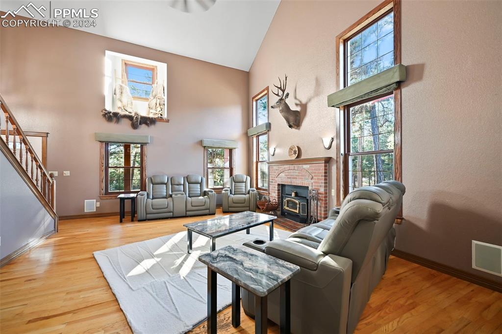 14560 Spiritwood Loop Elbert, CO 80106 - Photo 18 of 44 a living room with furniture a fireplace and a large window