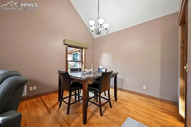 a view of a dining room with furniture and chandelier
