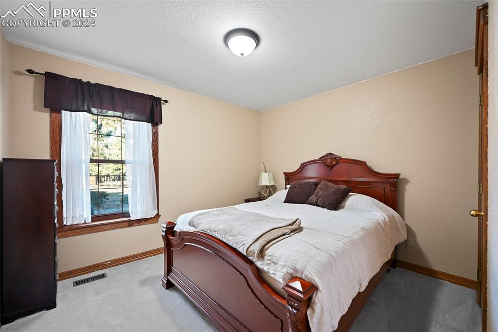 14560 Spiritwood Loop Elbert, CO 80106 - Photo 27 of 44 a bedroom with a bed and window