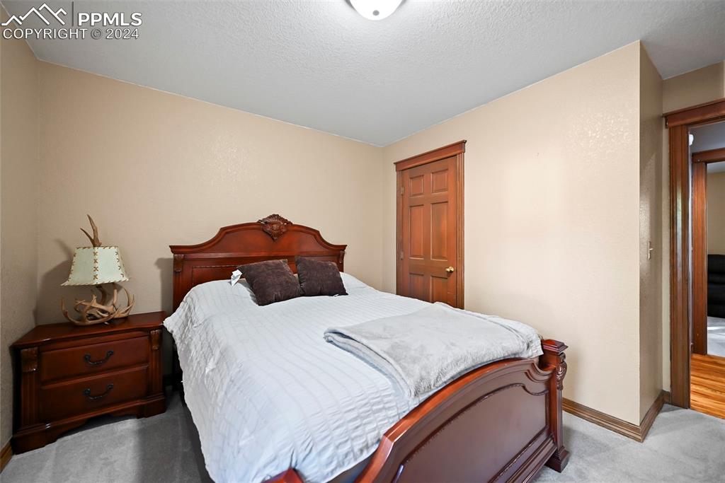 14560 Spiritwood Loop Elbert, CO 80106 - Photo 28 of 44 a bedroom with a bed and a lamp