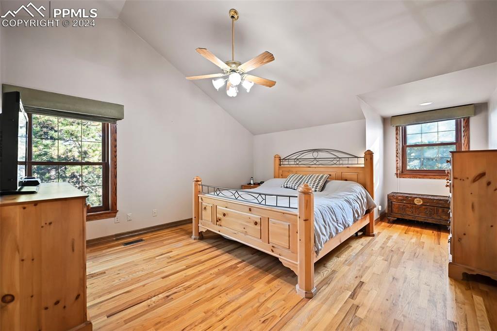 14560 Spiritwood Loop Elbert, CO 80106 - Photo 30 of 44 a bedroom with a bed and wooden floor
