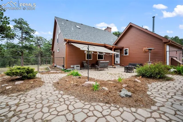 a backyard of a house with yard and outdoor seating