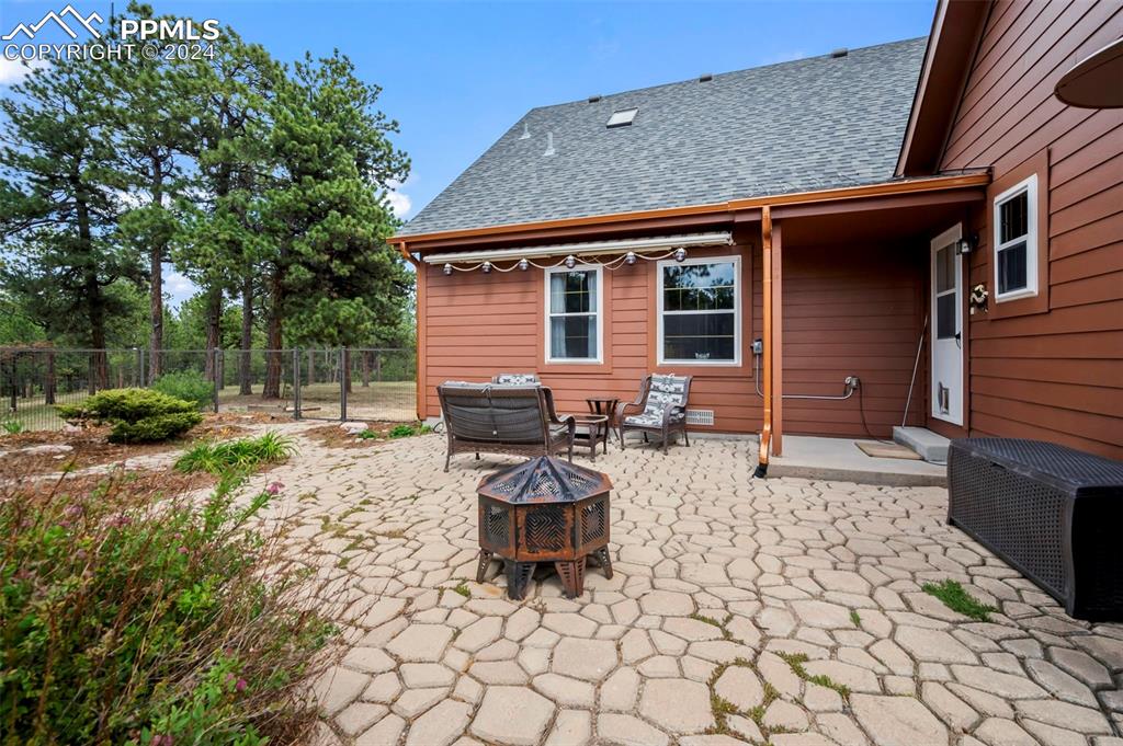 14560 Spiritwood Loop Elbert, CO 80106 - Photo 35 of 44 a backyard of a house with barbeque oven table and chairs