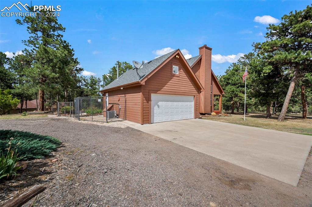14560 Spiritwood Loop Elbert, CO 80106 - Photo 4 of 44 a front view of a house with a yard and garage