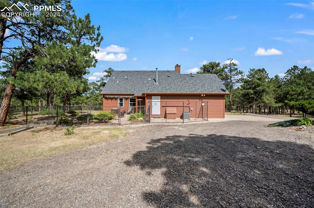 14560 Spiritwood Loop Elbert, CO 80106 - Photo 5 of 44 a front view of a house with a yard and garage