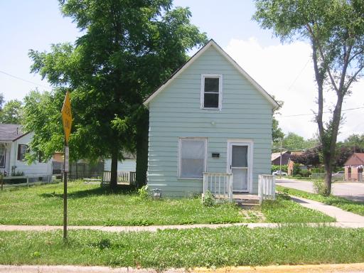 a view of backyard of house with green space