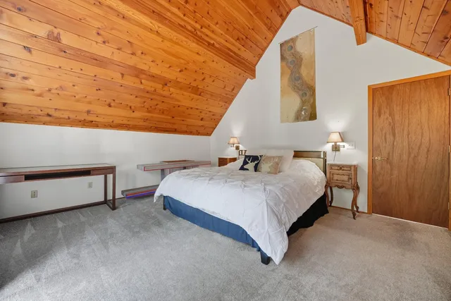 a bedroom with a bed and cabinets