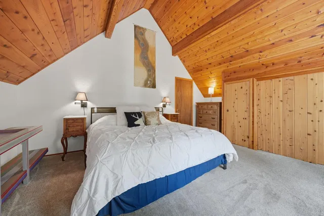 a bed sitting in a bedroom next to a window