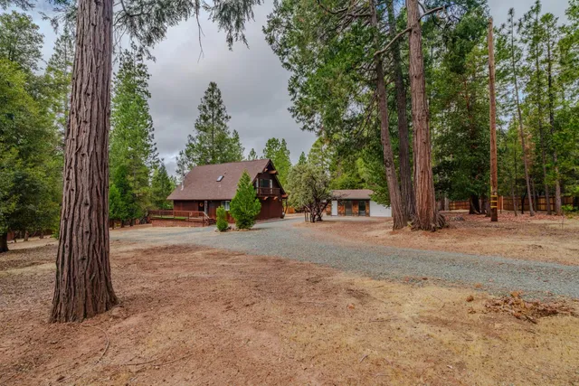a front view of a house with a yard and lake view