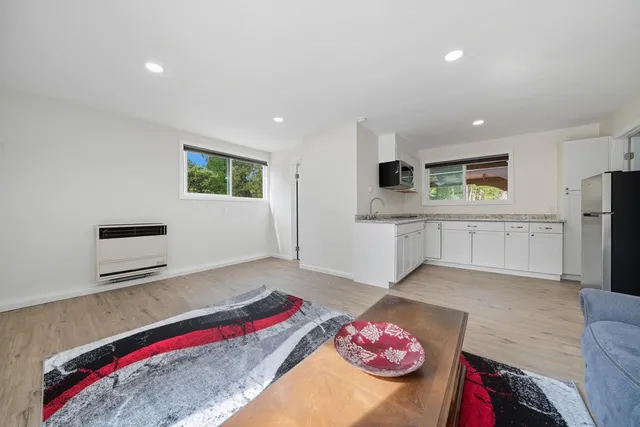 a living room with furniture and kitchen view