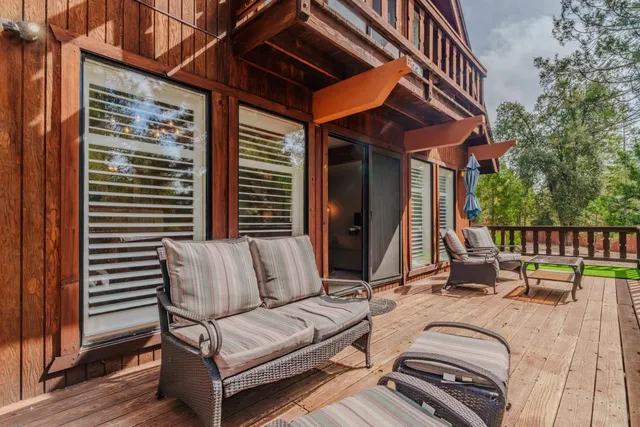 a view of a patio with couches chairs and wooden floor