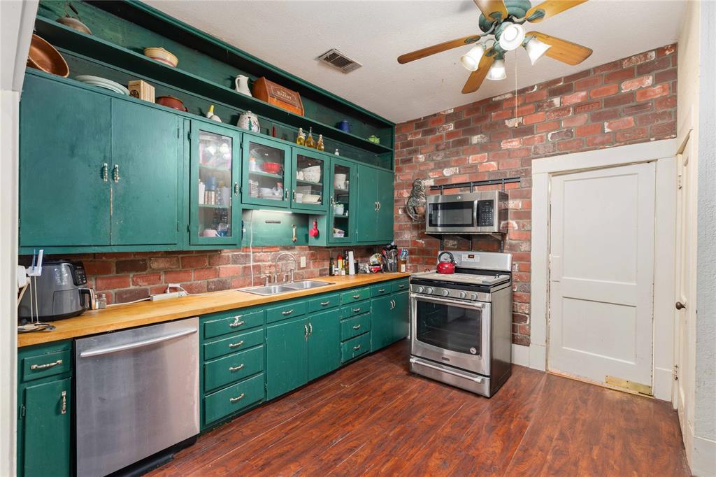 701 4th Street Goldthwaite, TX 76844 - Photo 13 of 32 a kitchen with stainless steel appliances granite countertop a sink and cabinets