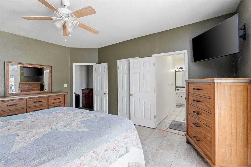 701 4th Street Goldthwaite, TX 76844 - Photo 14 of 32 a bedroom with a bed and a flat screen tv