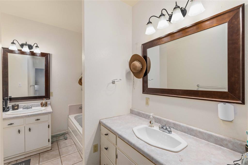 701 4th Street Goldthwaite, TX 76844 - Photo 16 of 32 a bathroom with a sink and a mirror