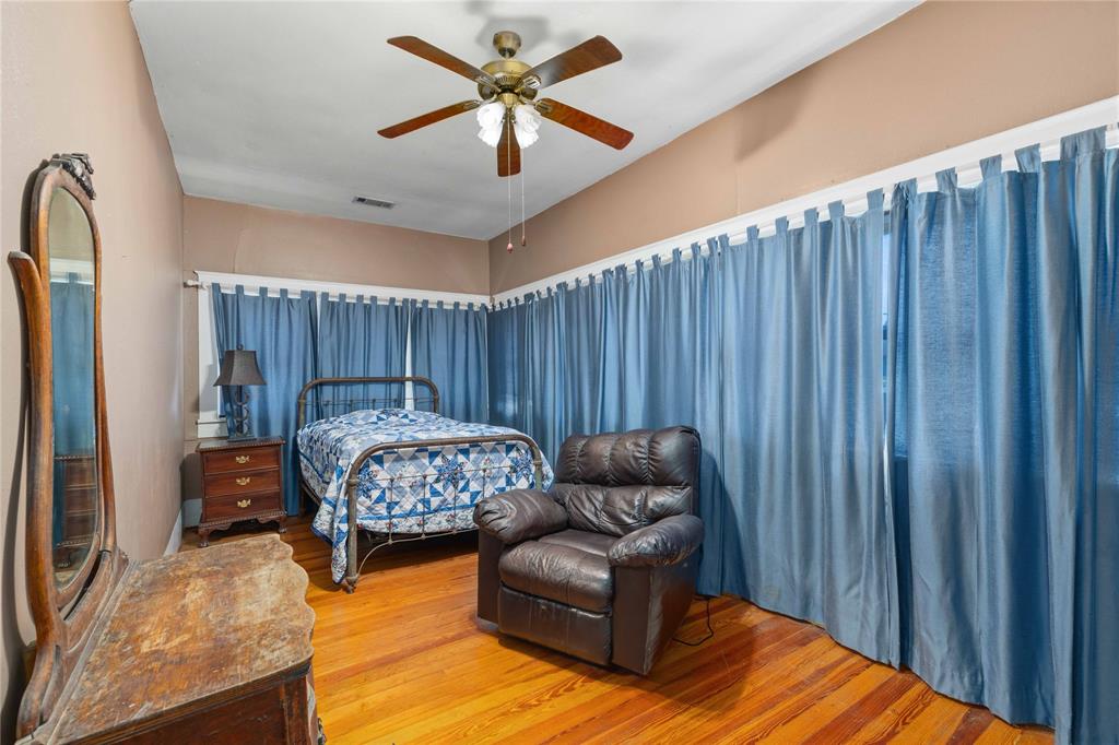 701 4th Street Goldthwaite, TX 76844 - Photo 19 of 32 a bedroom with furniture and a chandelier