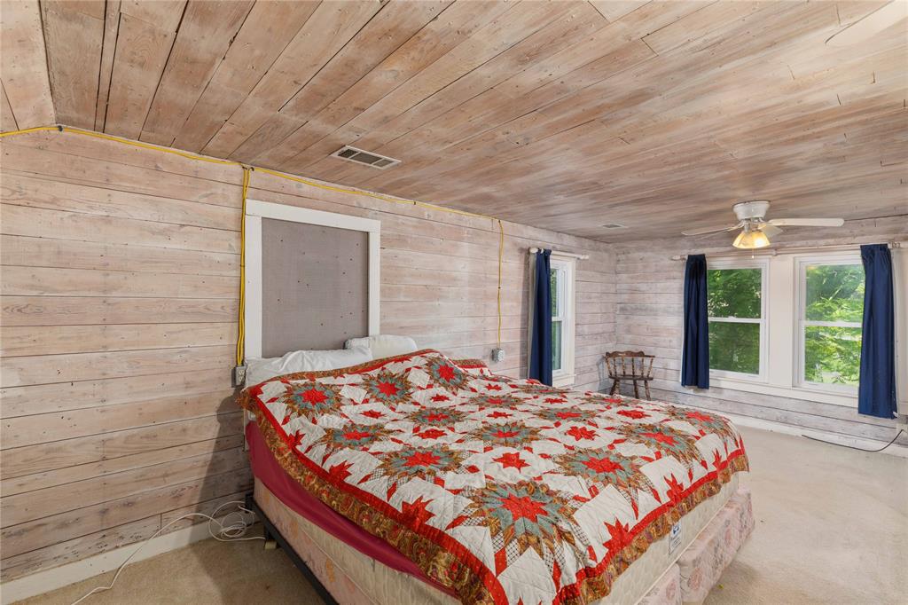 701 4th Street Goldthwaite, TX 76844 - Photo 23 of 32 a bed sitting in a spacious bedroom next to a window