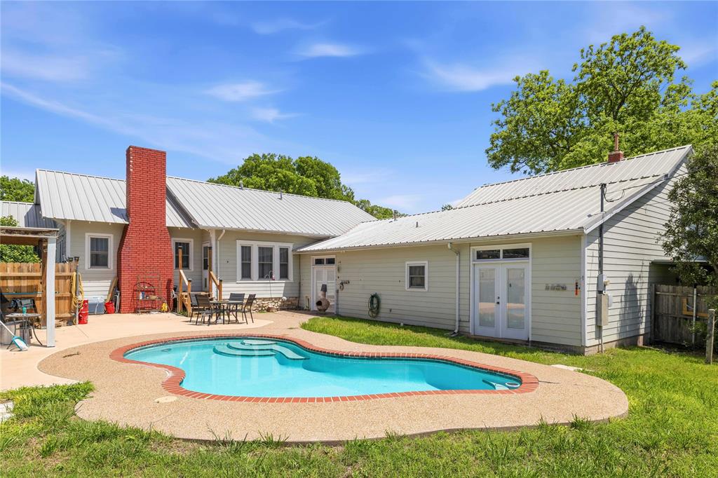 701 4th Street Goldthwaite, TX 76844 - Photo 4 of 32 a view of a house with swimming pool and yard
