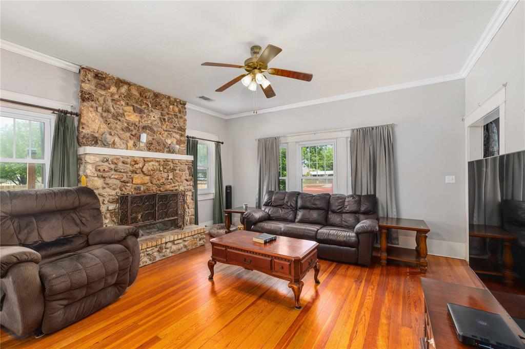 701 4th Street Goldthwaite, TX 76844 - Photo 6 of 32 a living room with furniture and a fireplace