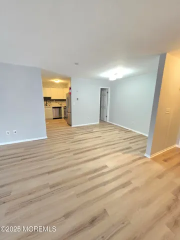 a view of a bedroom with wooden floor and bathroom
