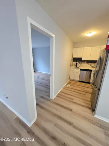 a kitchen with granite countertop a stove top oven and cabinets