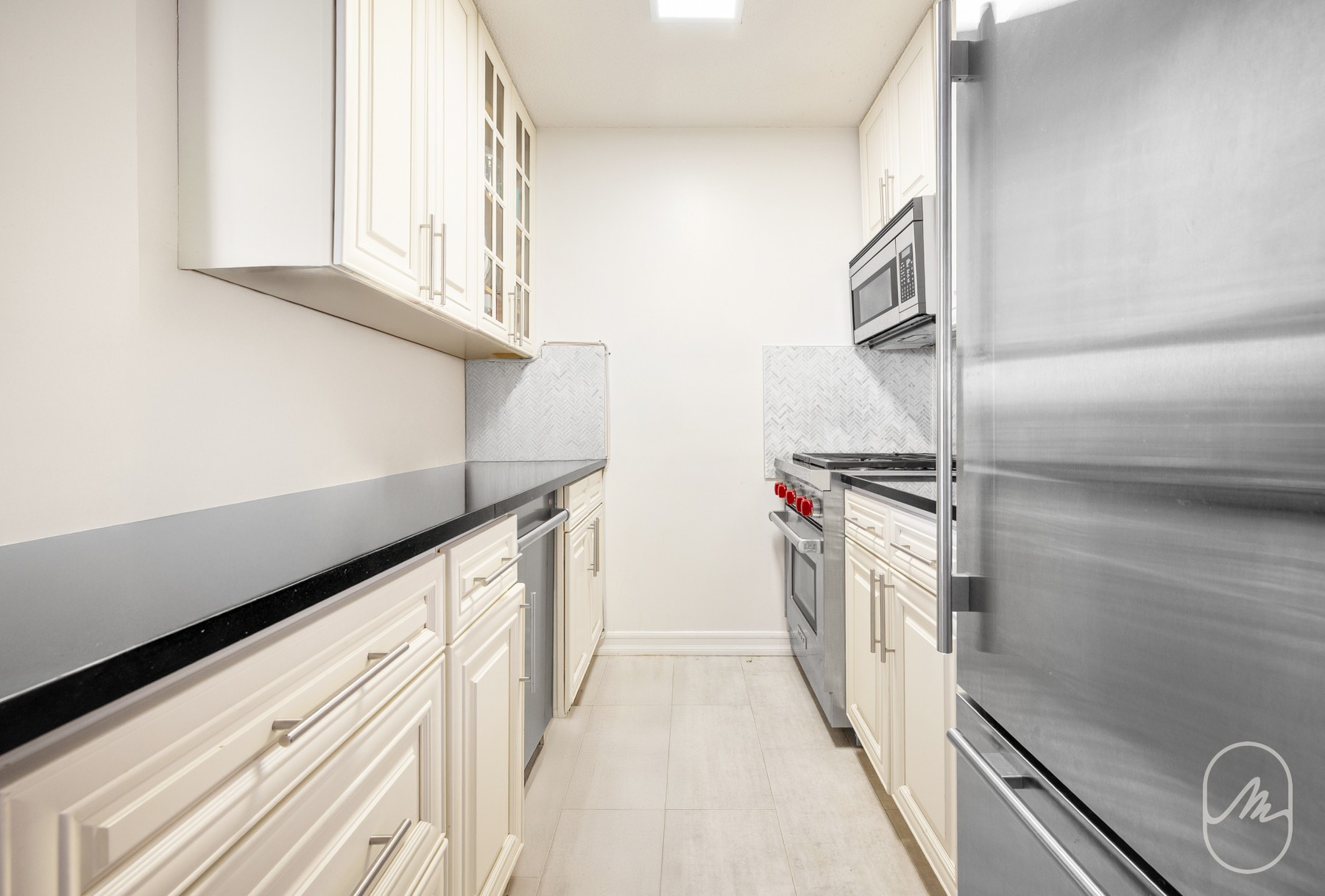 330 East 38th Street, Unit 23Q Manhattan, NY 10016 - Photo 8 of 30 a kitchen with a refrigerator and a stove