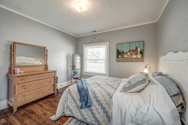 a bedroom with a bed and a dresser