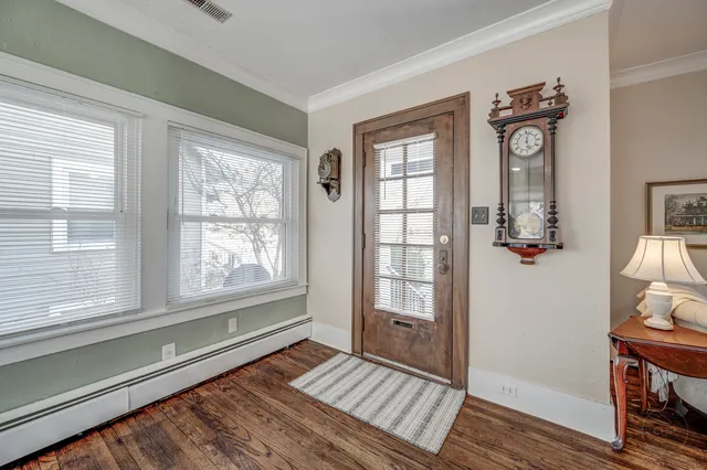 a view of an entryway with wooden floor