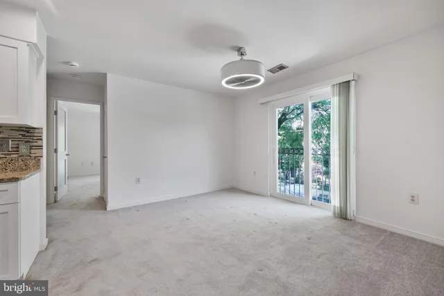 an empty room with windows and closet