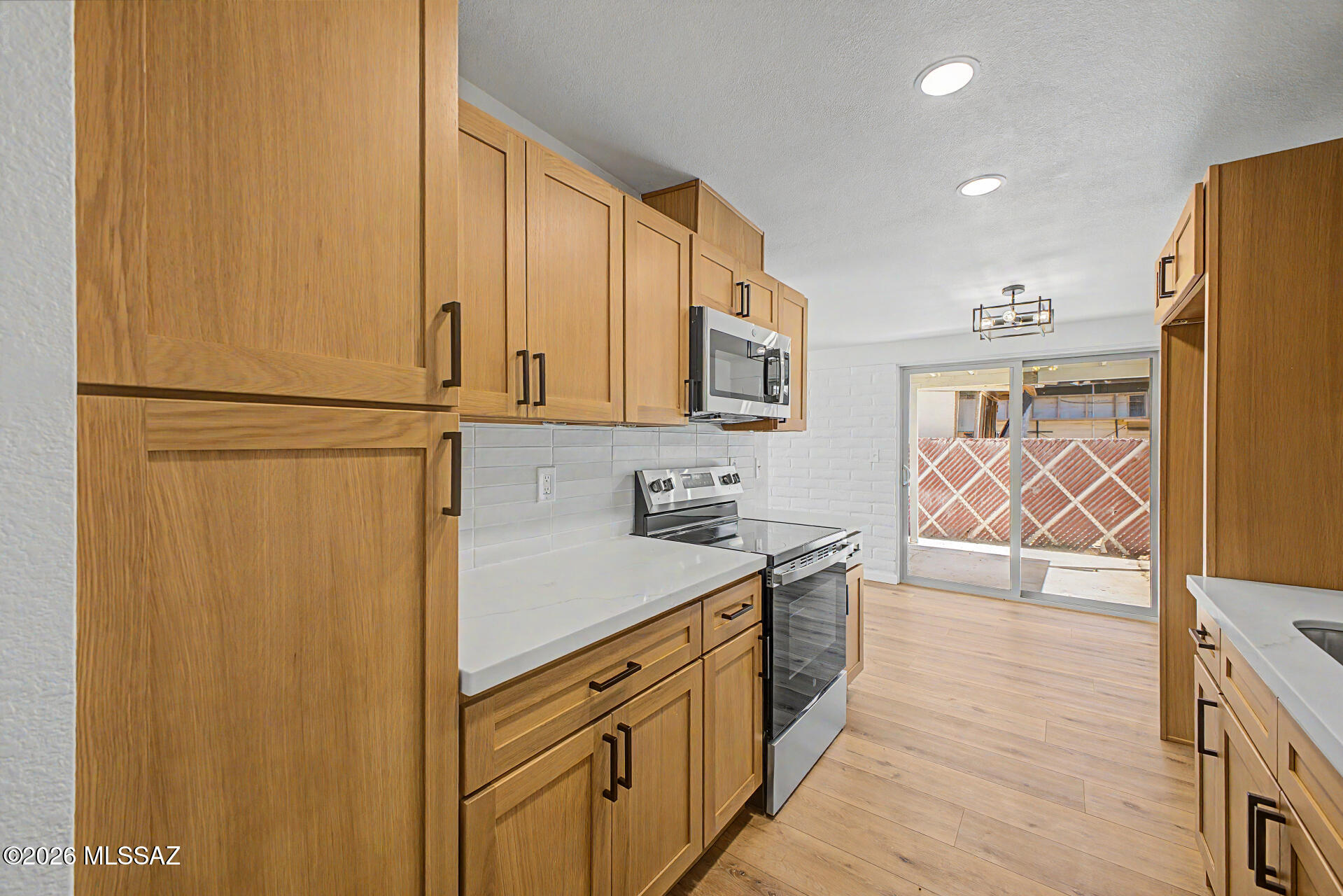 3402 South Kolb Road Tucson, AZ 85730 - Photo 5 of 32 a kitchen with stainless steel appliances a refrigerator sink and cabinets