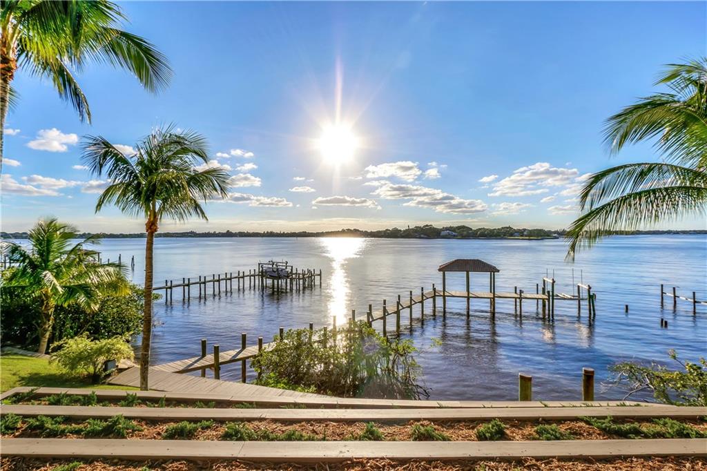171 South River Road Stuart, FL 34996 - Photo 13 of 68 a view of a swimming pool with a table and chairs