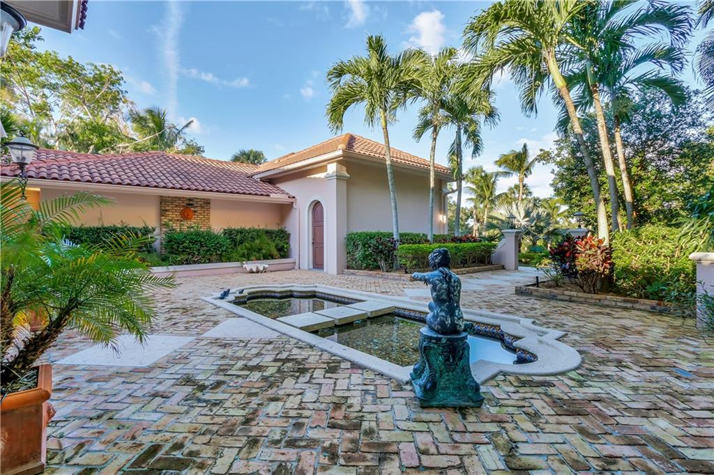 171 South River Road Stuart, FL 34996 - Photo 16 of 68 a front view of a house with garden and trees