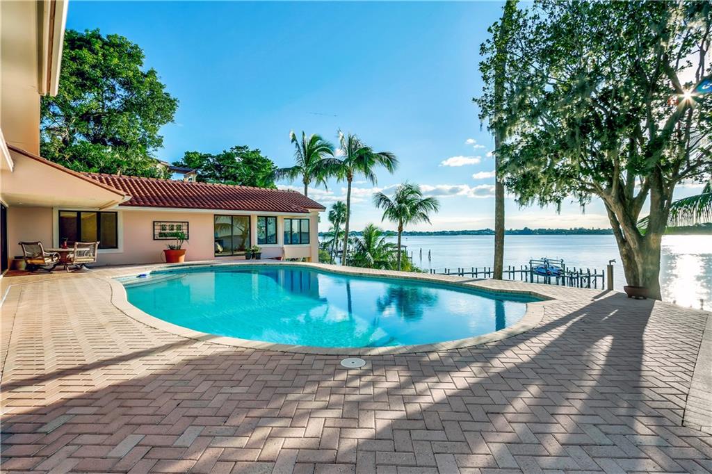 171 South River Road Stuart, FL 34996 - Photo 3 of 68 a view of a house with swimming pool and sitting area