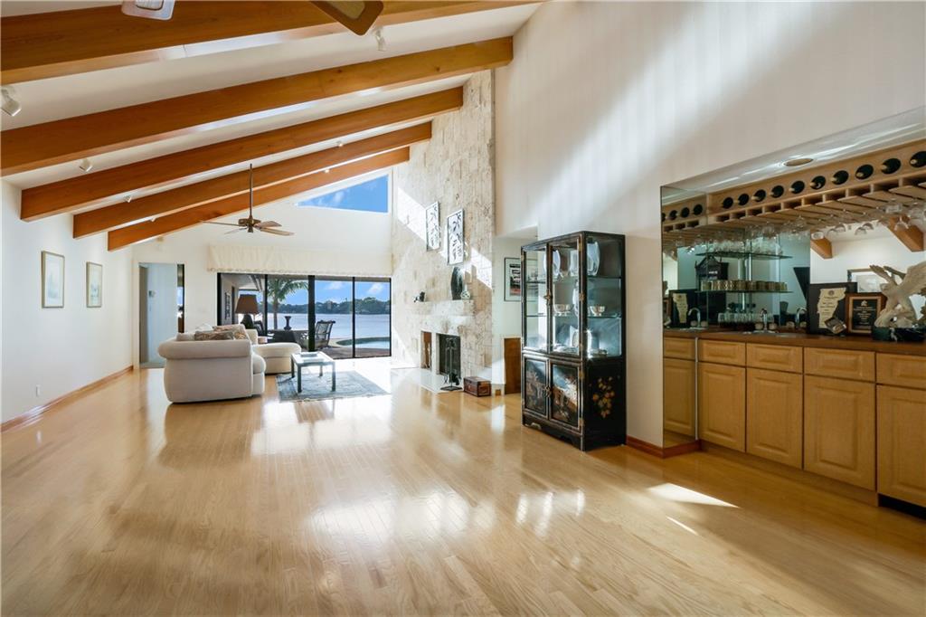 171 South River Road Stuart, FL 34996 - Photo 39 of 68 a living room with furniture and a chandelier