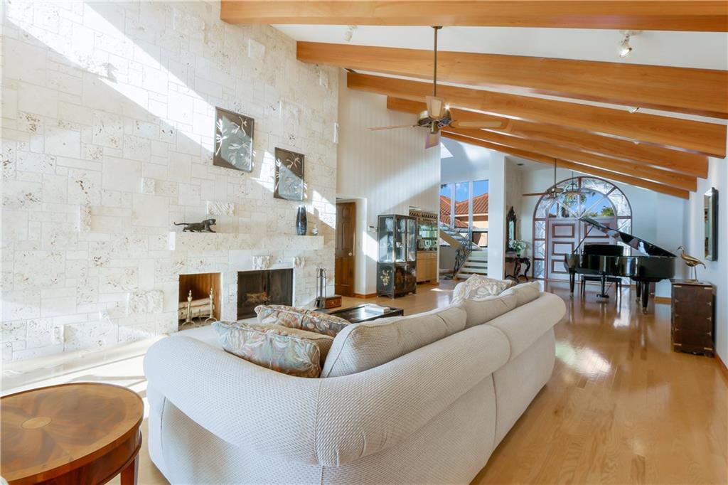 171 South River Road Stuart, FL 34996 - Photo 41 of 68 a living room with furniture a fireplace and a table