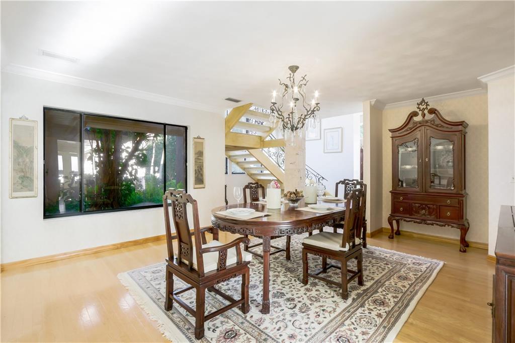 171 South River Road Stuart, FL 34996 - Photo 42 of 68 a view of a dining room with furniture wooden floor and a chandelier