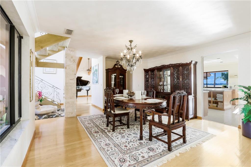 171 South River Road Stuart, FL 34996 - Photo 44 of 68 a view of a dining room with furniture a chandelier and wooden floor