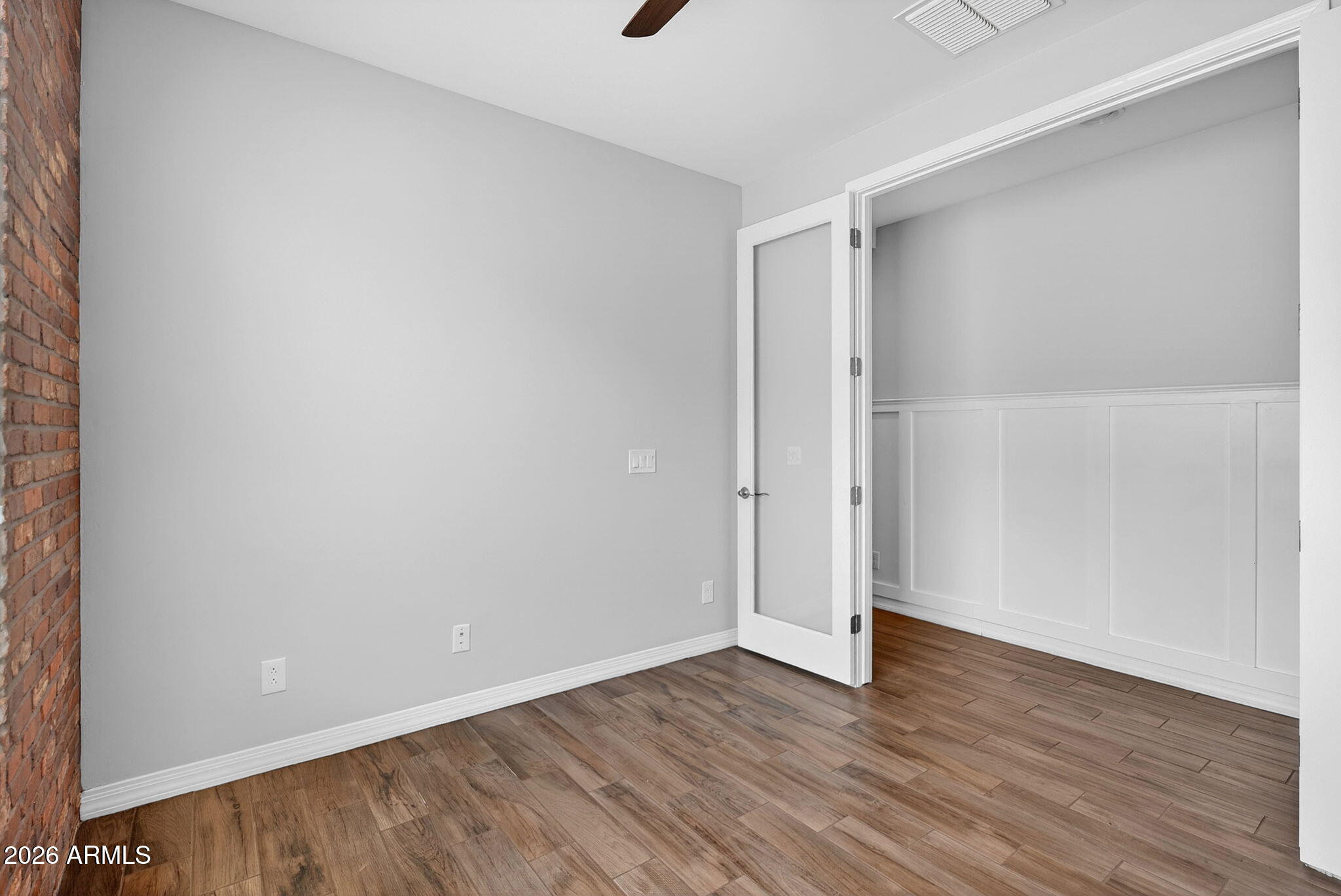 12124 West Peak View Road Peoria, AZ 85383 - Photo 15 of 38 a view of an empty room with wooden floor