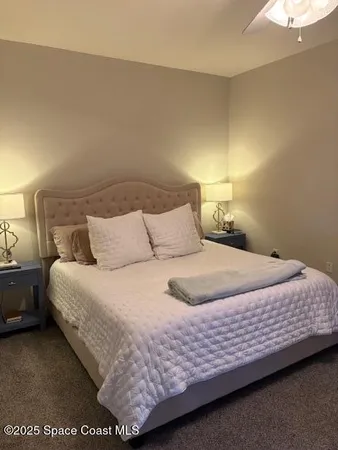 a bedroom with a bed and a lamp