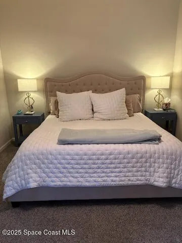 a bedroom with a bed dresser and mirror